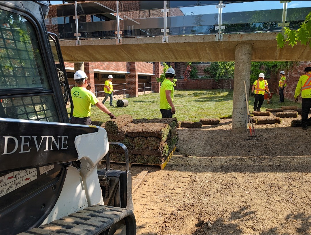 Devine Image crew laying sod at Sports Complex — drainage and grading completion